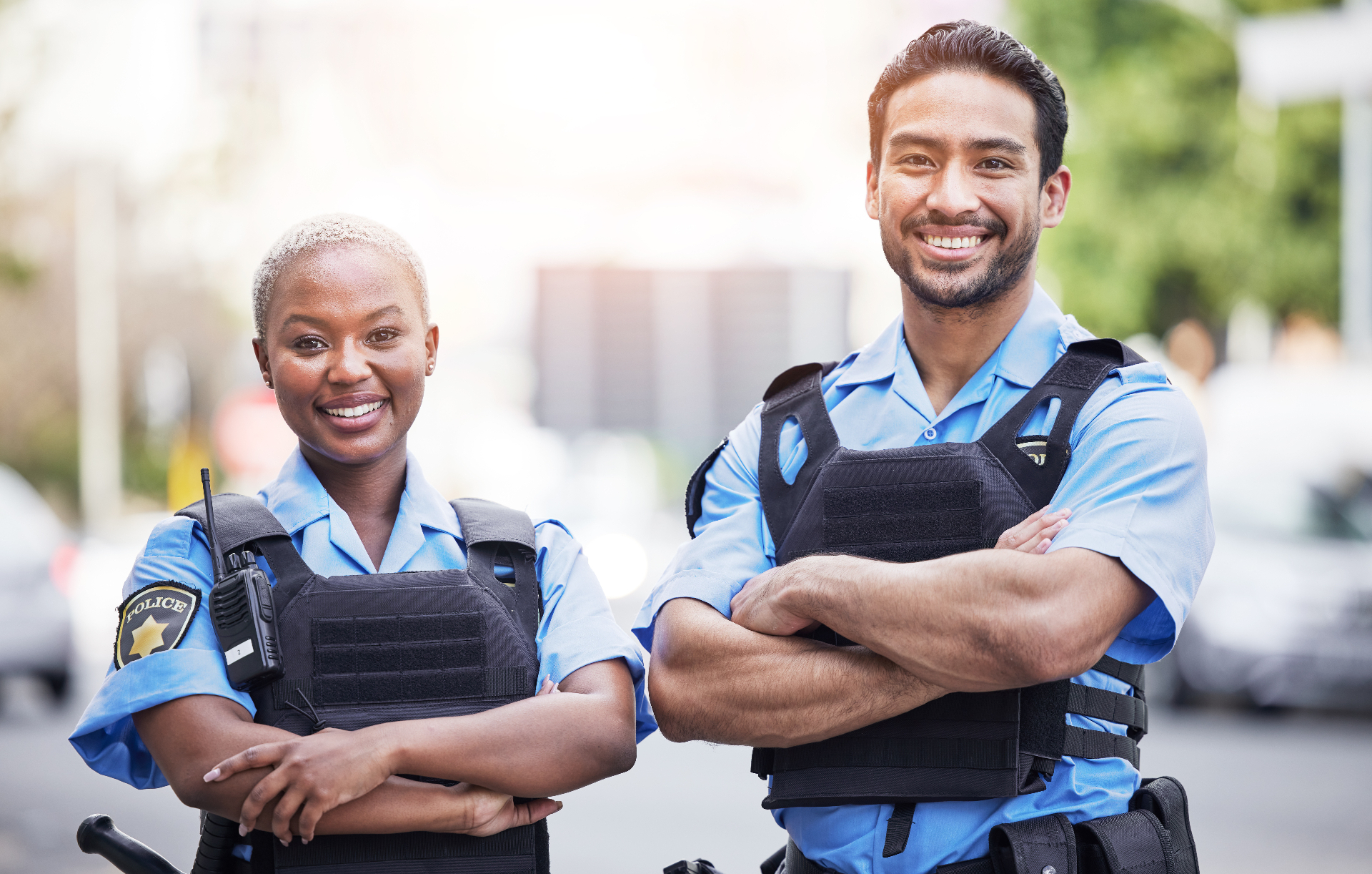 Two police officers standing confidently on a neighborhood street